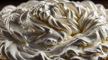 A close-up of a beautifully swirled whipped cream topping on a dessert. photo