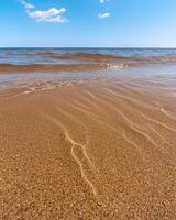 Serene beach scene with calm waves and sandy shore photo