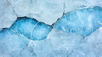 Cracked and frozen blue ice texture background photo