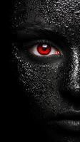 Intense red eye in dark, wet environment photo
