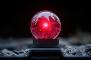 Glowing red orb on black background photo