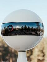 Surreal winter landscape reflected in a crystal ball photo