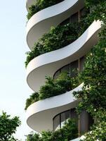 modern architectural building with curved balconies and lush greenery photo
