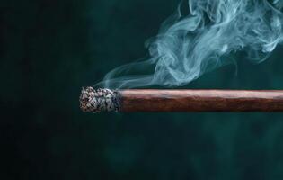 Smoldering cigar with smoke photo