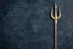 golden trident on dark background photo