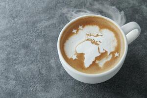 steaming hot coffee with world map latte art photo