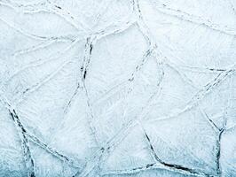 Intricate patterns of frost on a cold surface photo