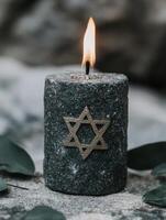 Burning candle with star of david symbol photo