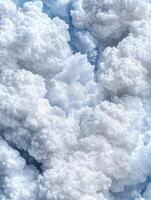 Fluffy white clouds in a blue sky photo