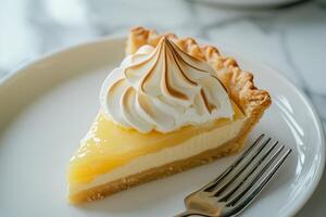 Delicious lemon meringue pie slice on a plate photo
