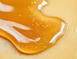 close up of golden honey dripping from a spoon photo