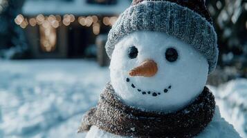 Closeup of a cute snowman with a knitted hat and scarf photo