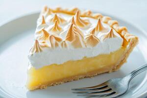 Delicious lemon meringue pie slice on a plate photo