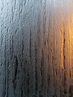 Rainy window with sunset reflection photo