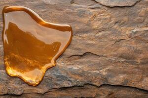 Amber Resin Specimen on Rugged Stone Background photo