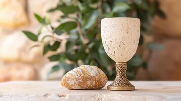 communion bread and chalice on wooden table photo
