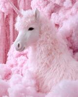 Fluffy white unicorn in a pink cloud like background photo