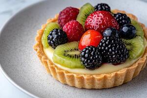 Delicious fruit tart with assorted berries and kiwi photo
