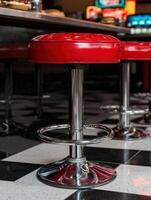 Retro red bar stool in diner setting photo