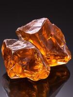 Amber crystals on a reflective surface photo