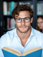 man reading book in library photo