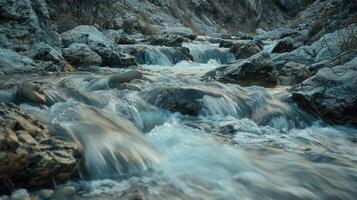Flowing mountain stream with cascading waterfalls photo