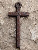 Rustic cross on weathered stone surface photo