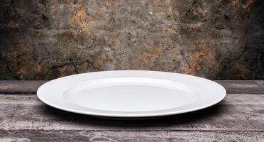 empty white plate on rustic wooden table photo