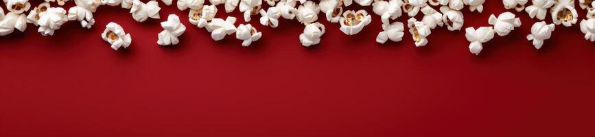 delicious popcorn on red background photo