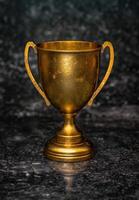 golden trophy on dark background photo