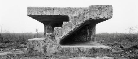 Abandoned concrete structure in a desolate landscape photo