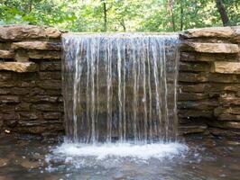 Serene waterfall in lush forest photo