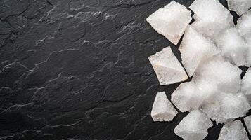 Shattered ice cubes on a dark slate background photo
