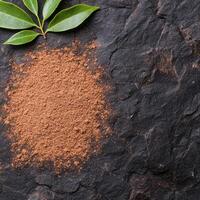 Spice and herb powder on dark slate background photo