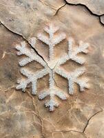 Intricate snowflake pattern on cracked surface photo