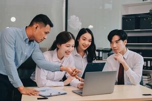 Entrepreneurs and business people conference in modern meeting room, happy multiracial coworkers have fun cooperating working together at office meeting, asian teamwork concept photo