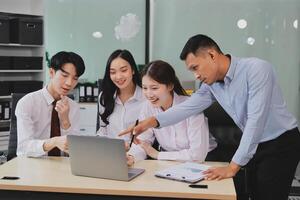 Entrepreneurs and business people conference in modern meeting room, happy multiracial coworkers have fun cooperating working together at office meeting, asian teamwork concept photo