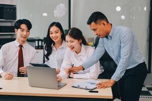 Entrepreneurs and business people conference in modern meeting room, happy multiracial coworkers have fun cooperating working together at office meeting, asian teamwork concept photo