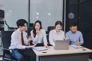 Entrepreneurs and business people conference in modern meeting room, happy multiracial coworkers have fun cooperating working together at office meeting, asian teamwork concept photo