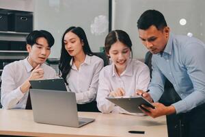 Entrepreneurs and business people conference in modern meeting room, happy multiracial coworkers have fun cooperating working together at office meeting, asian teamwork concept photo