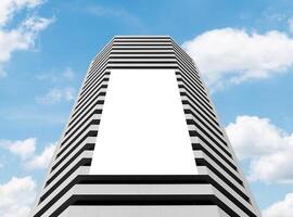 Mock up white vertical large LED display billboard on tower building. Clipping path for mockup photo