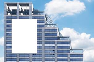 Mock up white vertical large LED display billboard on tower building. Clipping path for mockup photo