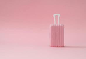 Pink suitcase on pastel pink background with copy space. Minimal travel concept. Trendy vacation idea. photo