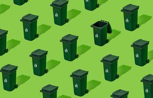 Creative eco pattern made of trash recycle bin on green background. Container for disposal garbage waste and save environment. Minimal earth day concept. Green eco pattern backdrop. photo