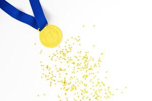 Golden medal on white background with golden glitter stars. Creative winner concept. Minimal victory backdrop idea. Flat lay. photo
