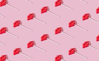 Trendy pattern made of red lips lollipops on pastel pink background. Minimal romantic layout. Creative candy idea. Colorful sweet food background. Valentines day concept with kisses. photo
