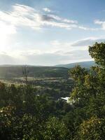 Scenic countryside landscape with rolling hills and lush greenery photo