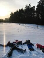 Children enjoying a playful day in the snowy landscape photo