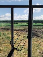 Peaceful rural landscape through a window with pitchfork shadow photo