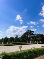 Elegant garden landscape with sculptures under a clear blue sky in Slavkov u Brna, Czech Republic. photo